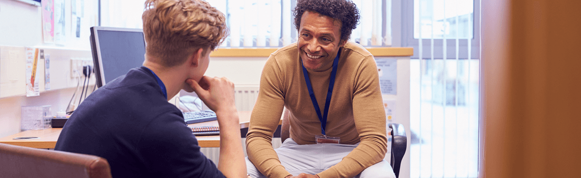 Two men sitting in an office discussing mental health